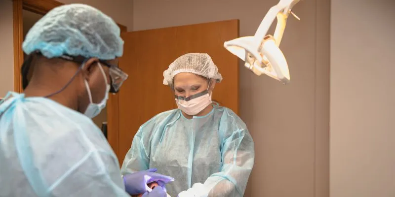 the doctor with his assistant during a procedure