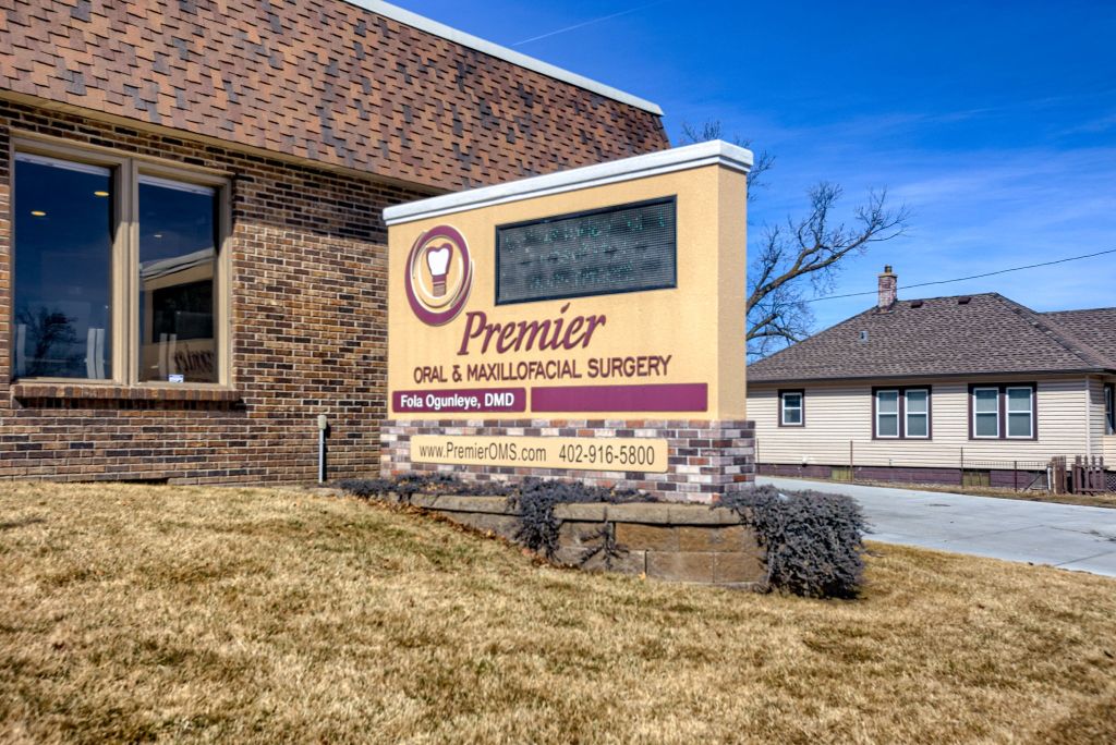 Photo of sign outside office building of Premier Oral Surgery.