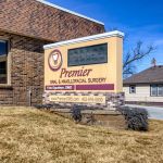 Photo of sign outside office building of Premier Oral Surgery.